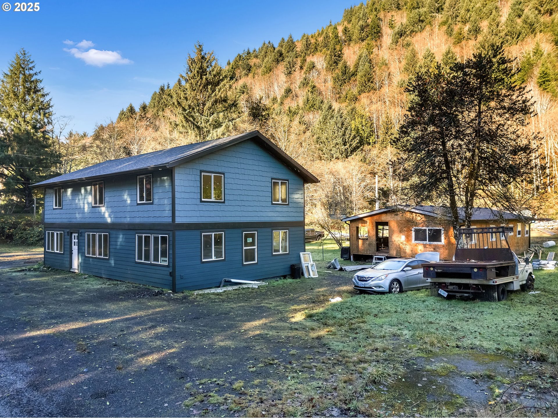 36375 Sunset Highway Seaside, OR 97138 - Photo 2 of 19 a front view of a house with a garden and trees