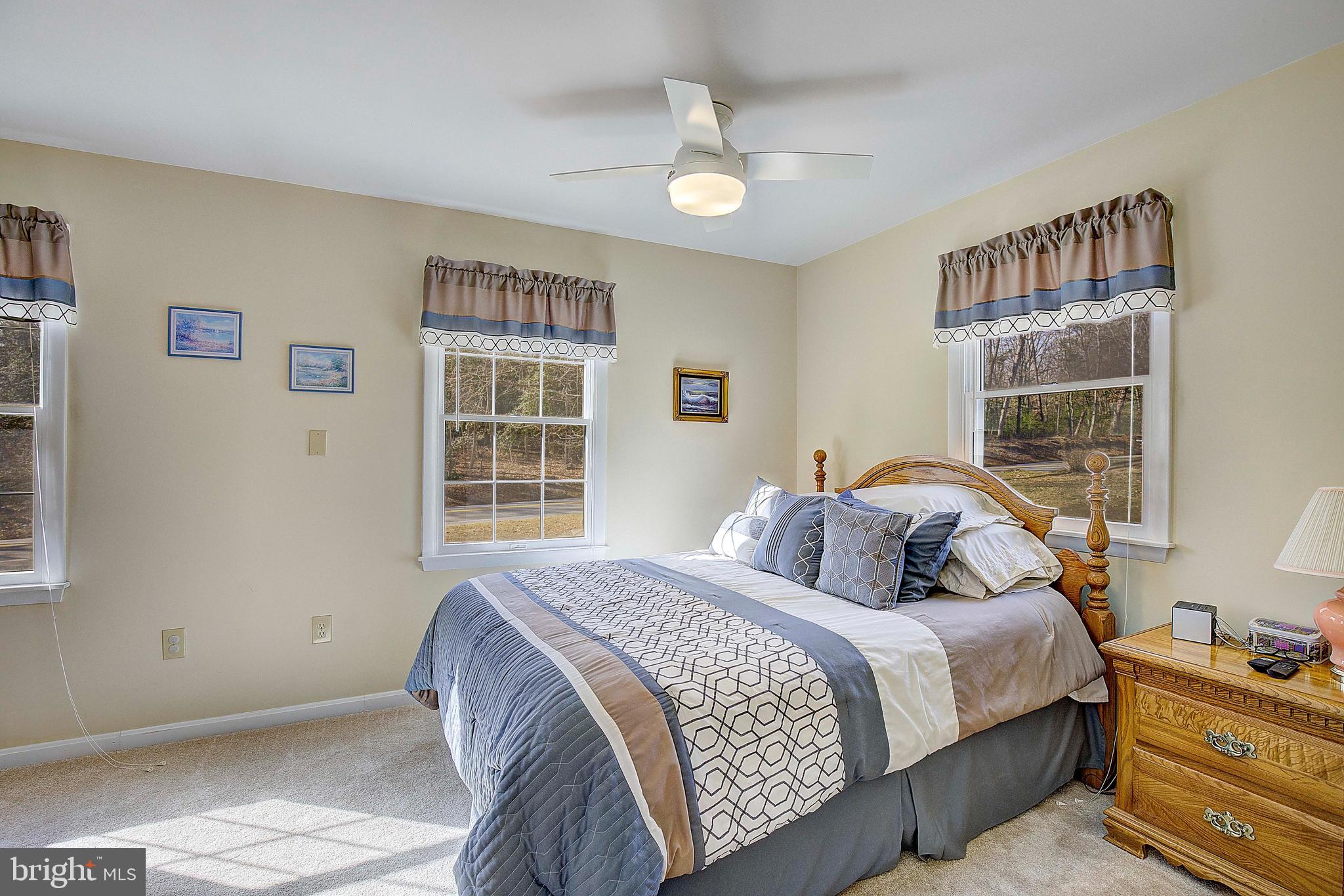 5018 Long Beach Road St. Leonard, MD 20685 - Photo 17 of 39 a bedroom with double bed and a window
