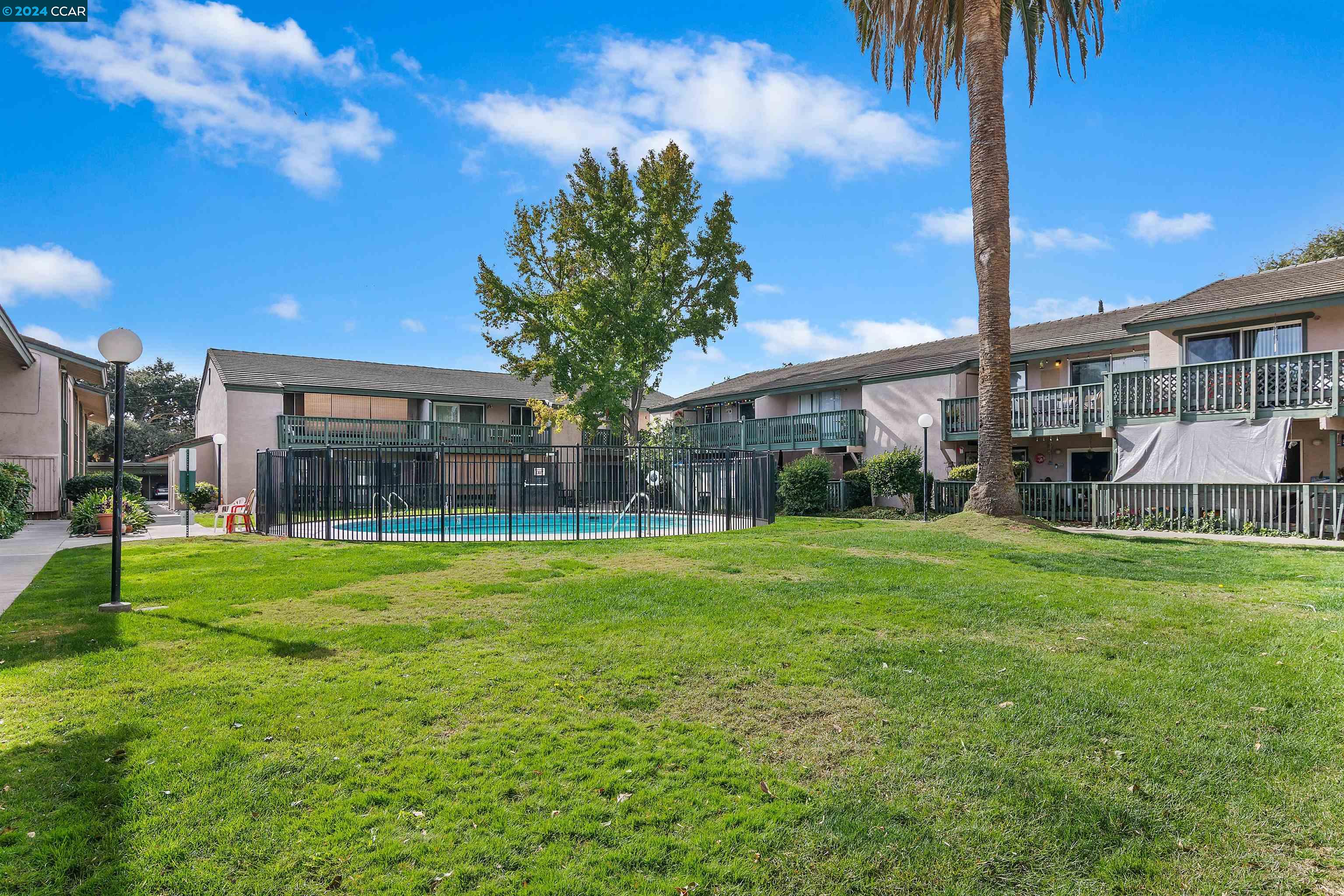 4888 Clayton Road, Unit 3 Concord, CA 94521 - Photo 1 of 1 a front view of house with yard and outdoor seating