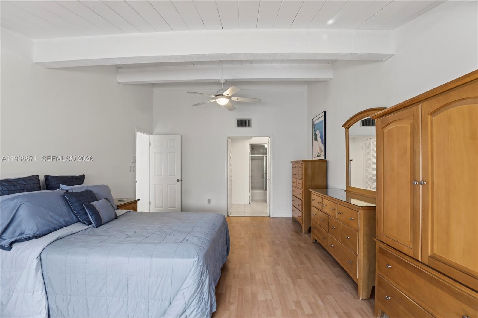 7673 Southwest 103rd Place Miami, FL 33173 - Photo 11 of 20 a bedroom with bed and wooden floor