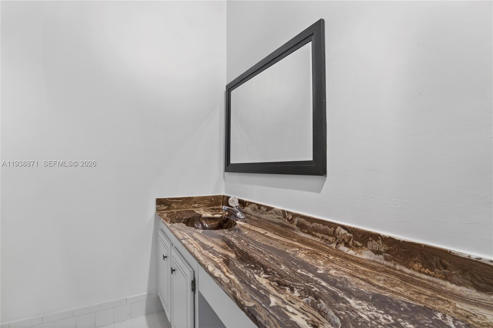 7673 Southwest 103rd Place Miami, FL 33173 - Photo 14 of 20 a bathroom with a sink and a mirror