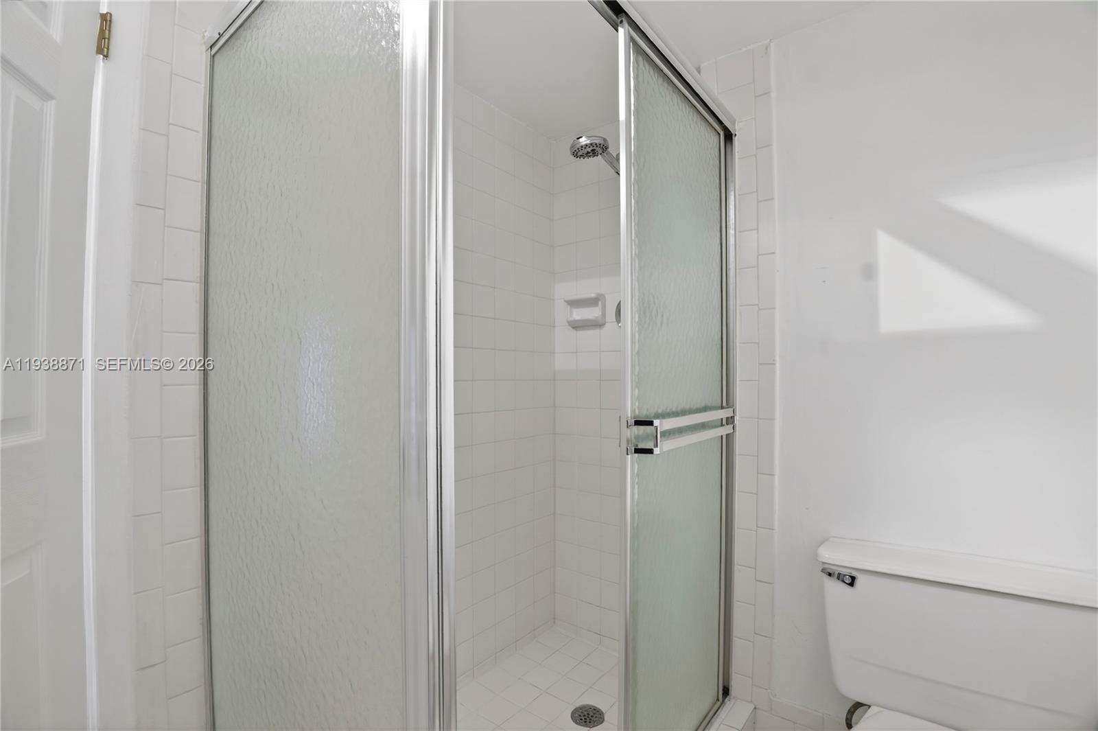 7673 Southwest 103rd Place Miami, FL 33173 - Photo 15 of 20 a bathroom with a shower and toilet