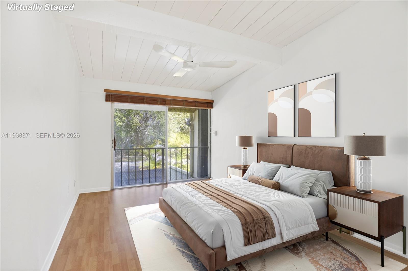 7673 Southwest 103rd Place Miami, FL 33173 - Photo 16 of 20 a bedroom with a large bed and a large window