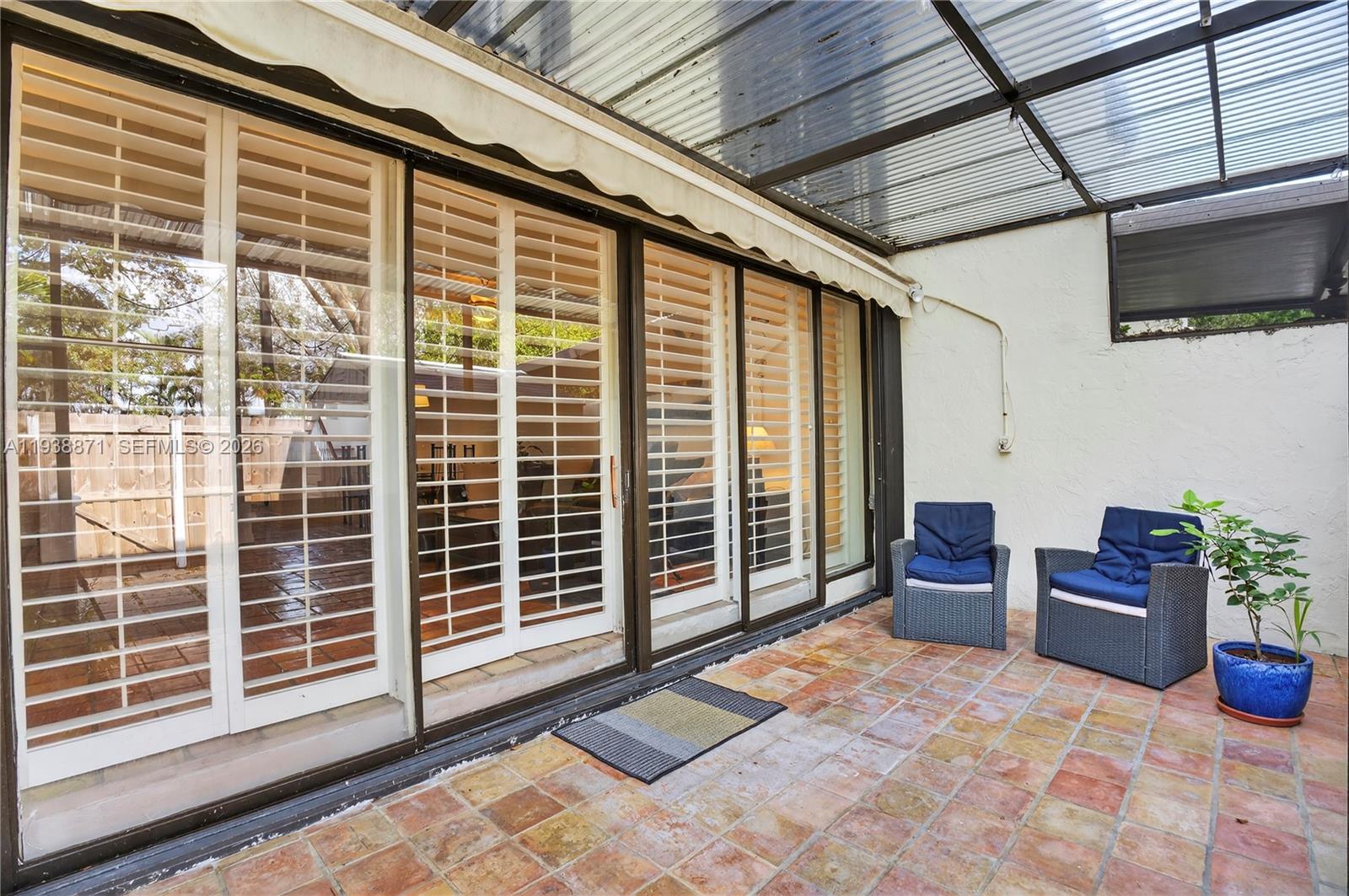 7673 Southwest 103rd Place Miami, FL 33173 - Photo 17 of 20 a view of a porch with furniture