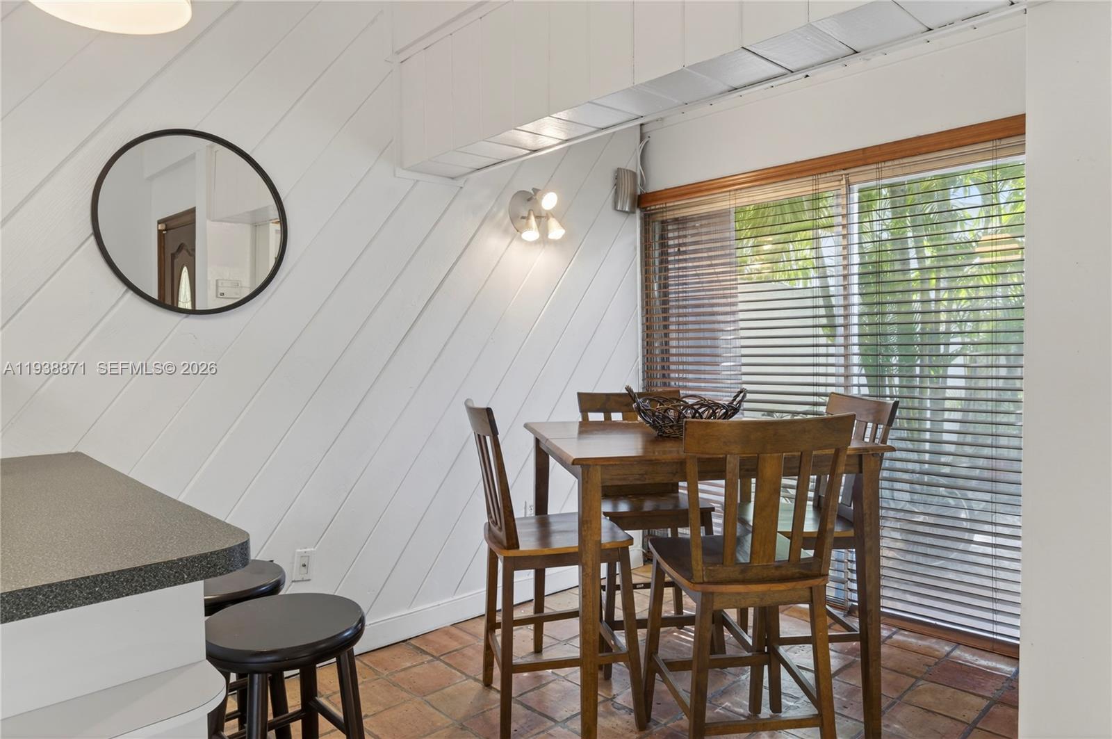 7673 Southwest 103rd Place Miami, FL 33173 - Photo 6 of 20 a view of a dining room with furniture and a large window
