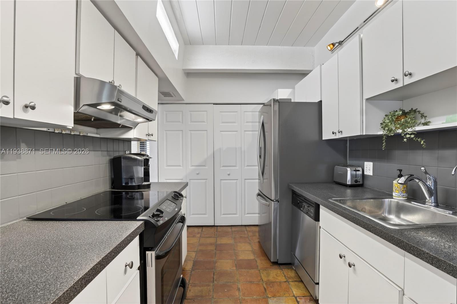 7673 Southwest 103rd Place Miami, FL 33173 - Photo 8 of 20 a kitchen with a sink appliances and cabinets