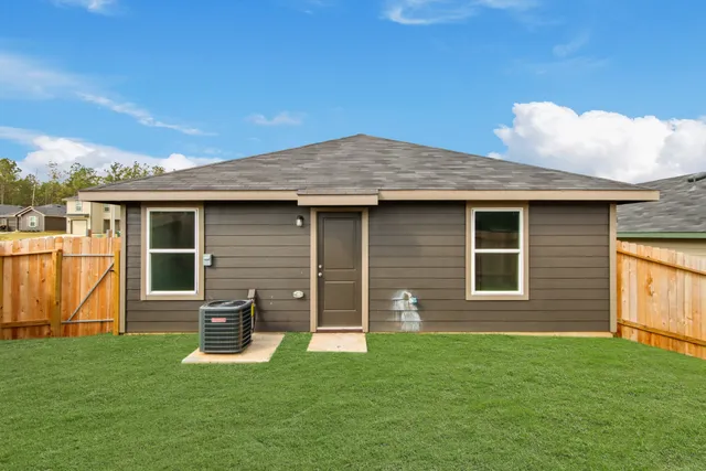 a view of a house with a backyard