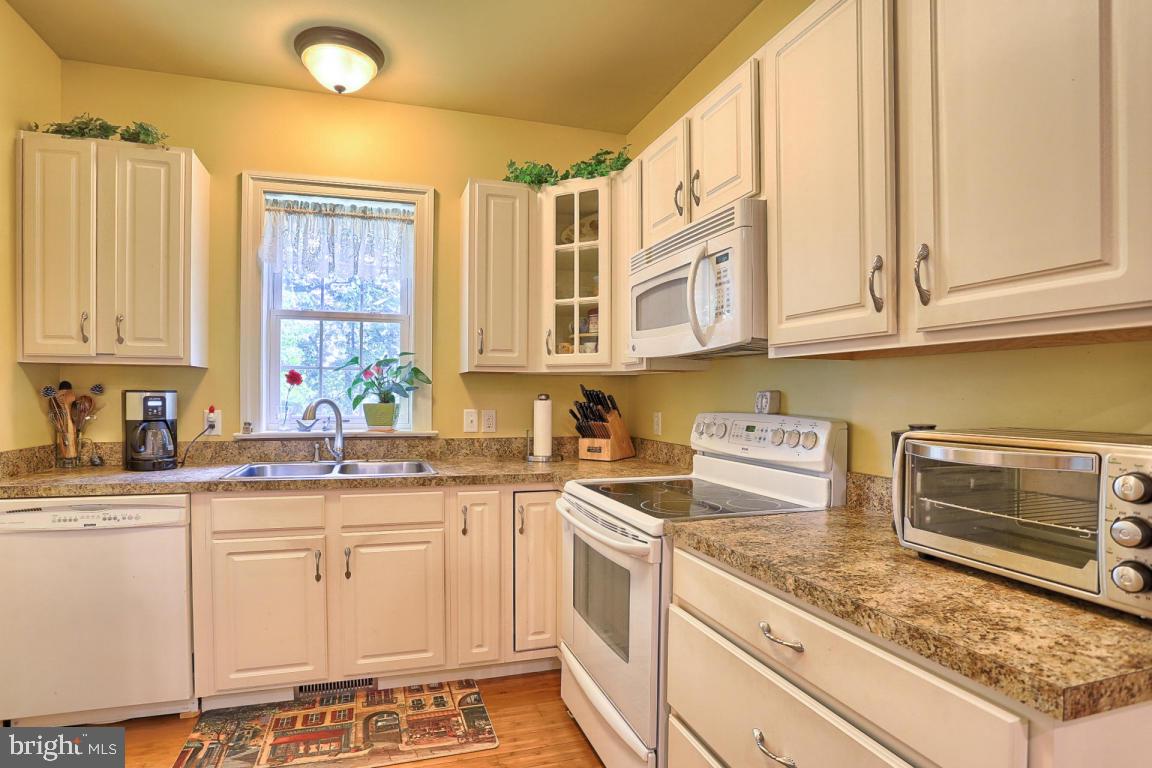 369 Nottingham Road Quarryville, PA 17566 - Photo 41 of 57 a kitchen with stainless steel appliances granite countertop a sink stove and cabinets