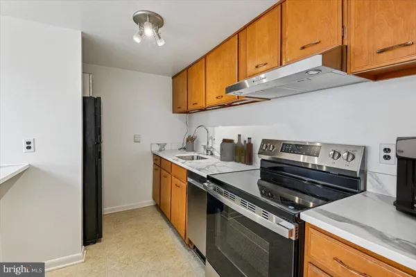 a kitchen with stainless steel appliances granite countertop a sink and a stove