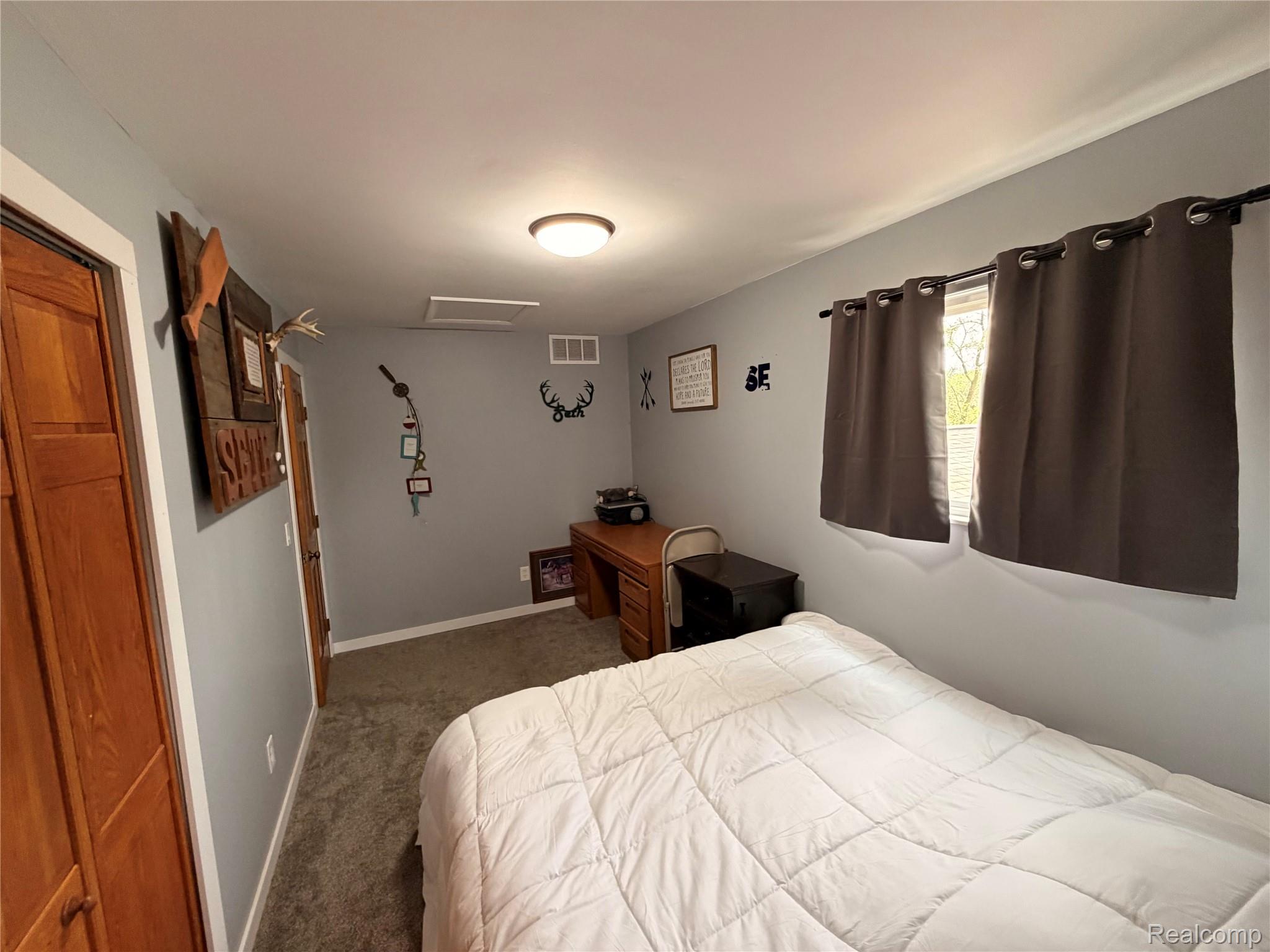 2712 North Branch Road North Branch, MI 48461 - Photo 26 of 37 Bedroom with attic access and dark colored carpet