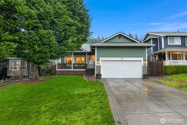 a front view of a house with a yard and garage