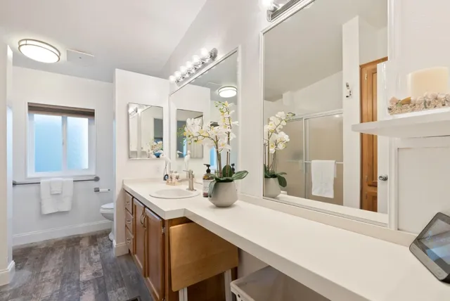 a bathroom with a double vanity sink mirror and shower
