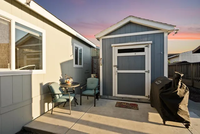 a view of a house with backyard and furniture