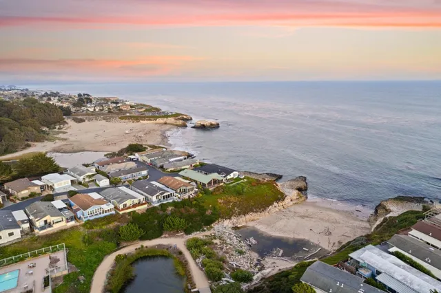 a front view of a house with plants and outdoor seating