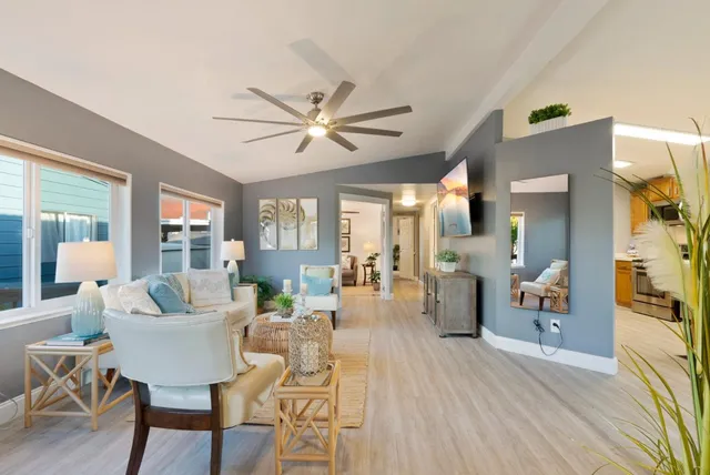 a living room with furniture and a wooden floor