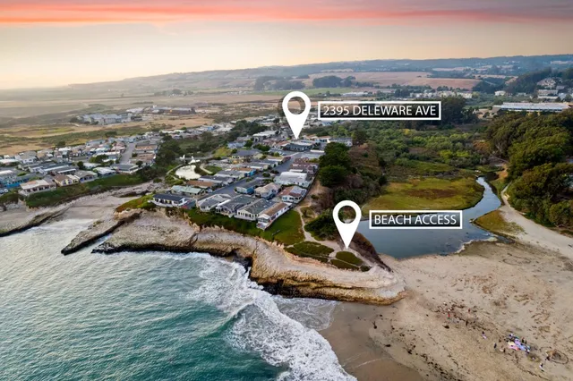 a living room with furniture large window and wooden floor