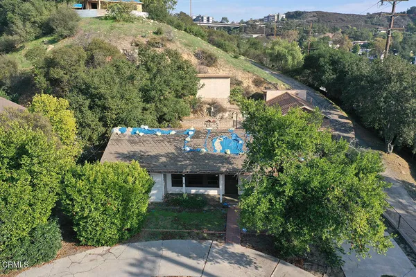 an aerial view of a house with a yard and garden