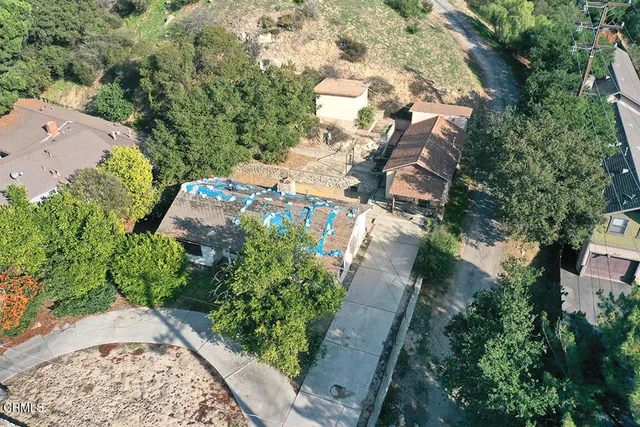 an aerial view of a house with a yard and garden