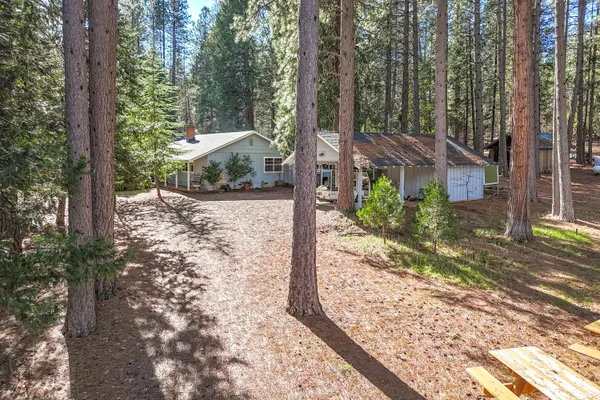 a kitchen with stainless steel appliances granite countertop a sink dishwasher stove and cabinets with wooden floor