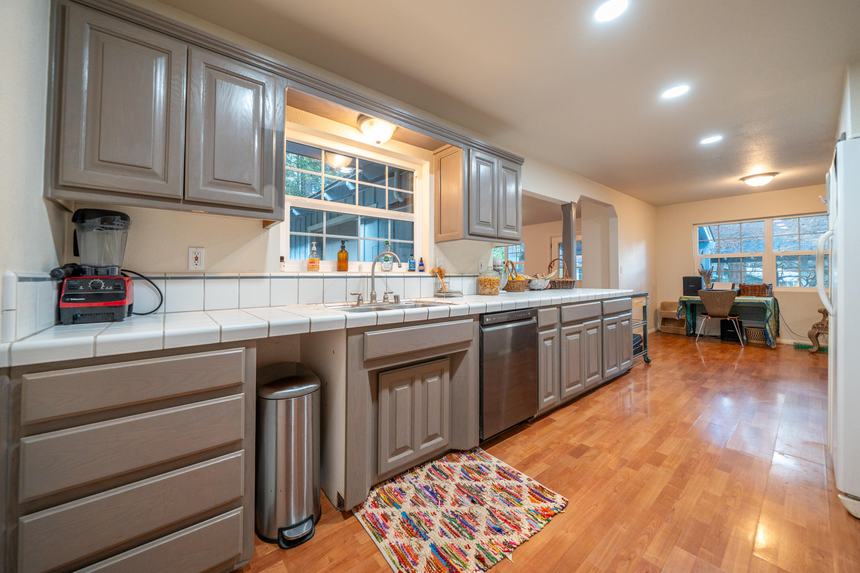 29276 Bullskin Ridge Road Oak Run, CA 96069 - Photo 19 of 113 a kitchen with stainless steel appliances granite countertop a sink dishwasher stove and cabinets with wooden floor