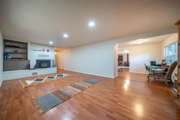 a bathroom with a sink a toilet a mirror a vanity a bath tub and shower