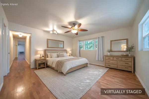 a spacious bedroom with a bed and a table in it