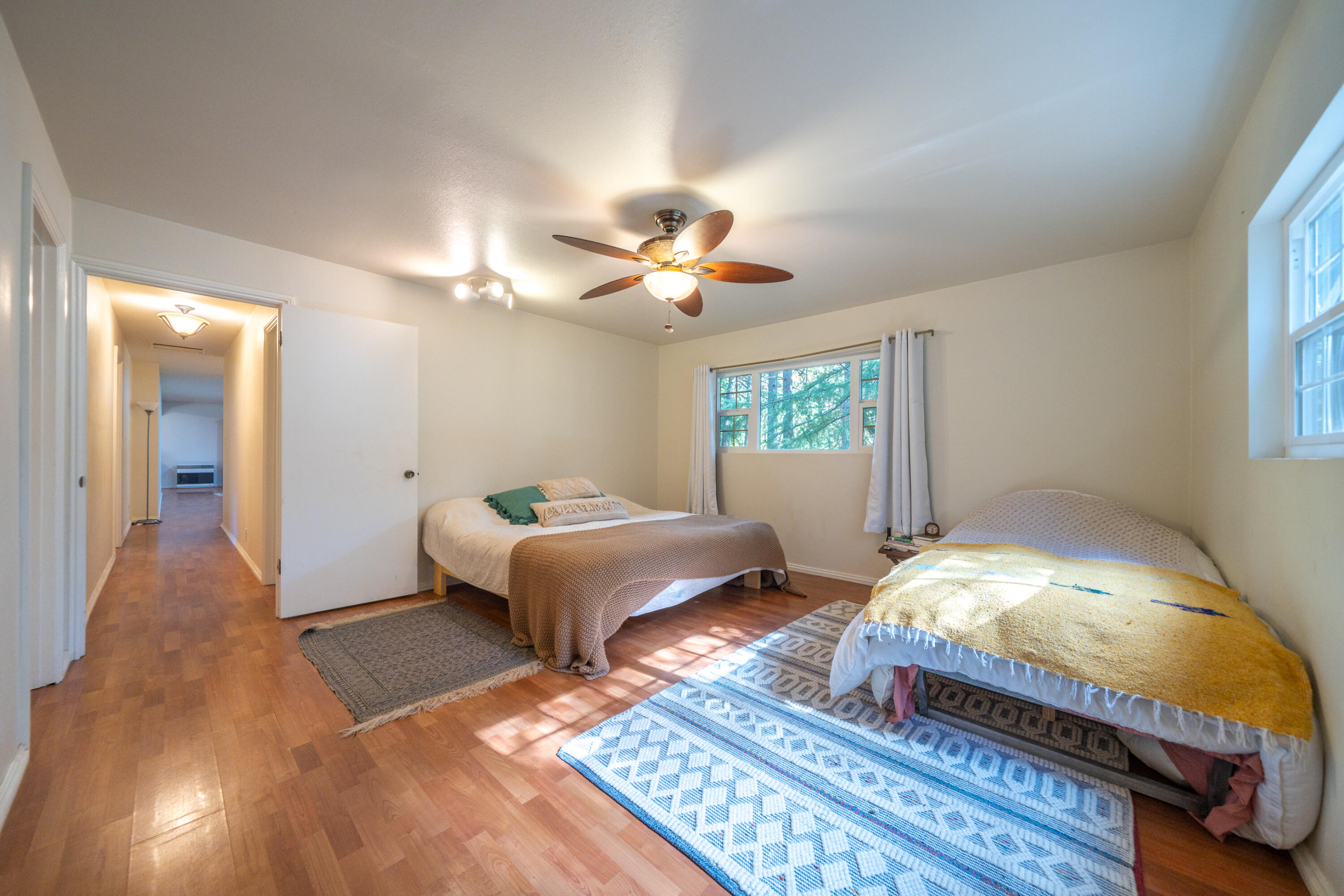 29276 Bullskin Ridge Road Oak Run, CA 96069 - Photo 29 of 113 a spacious bedroom with a bed and a chandelier
