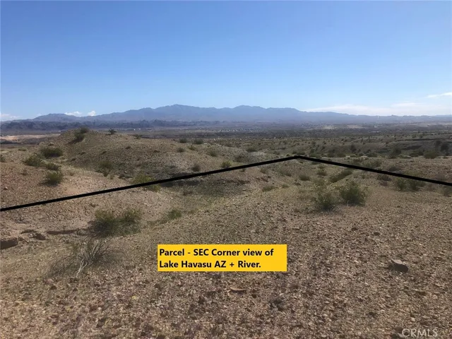 a view of a field with a mountain in the background