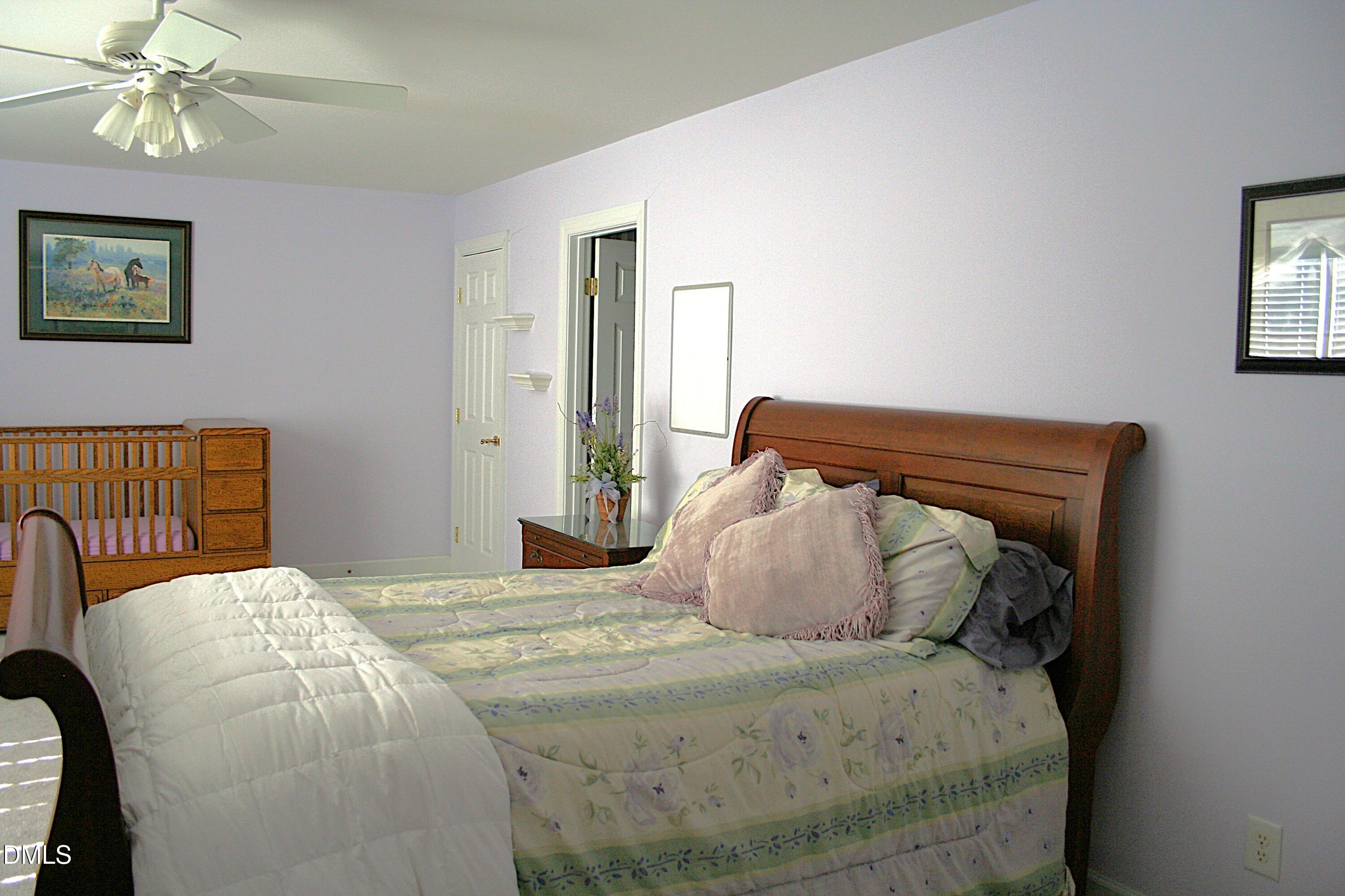 220 Jordan Narron Road Selma, NC 27576 - Photo 45 of 87 a bedroom with a bed and painting on the wall