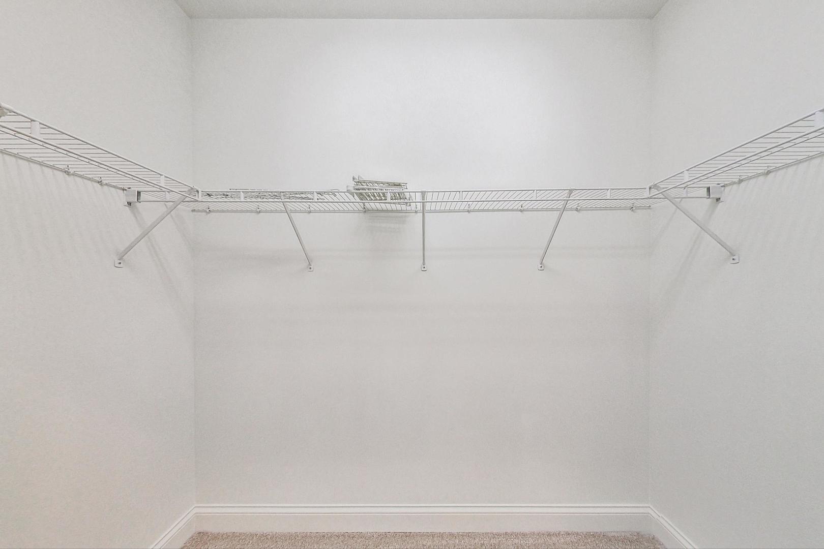620 McHenry Road, Unit 407 Wheeling, IL 60090 - Photo 14 of 23 a view of a room with racks on the wall