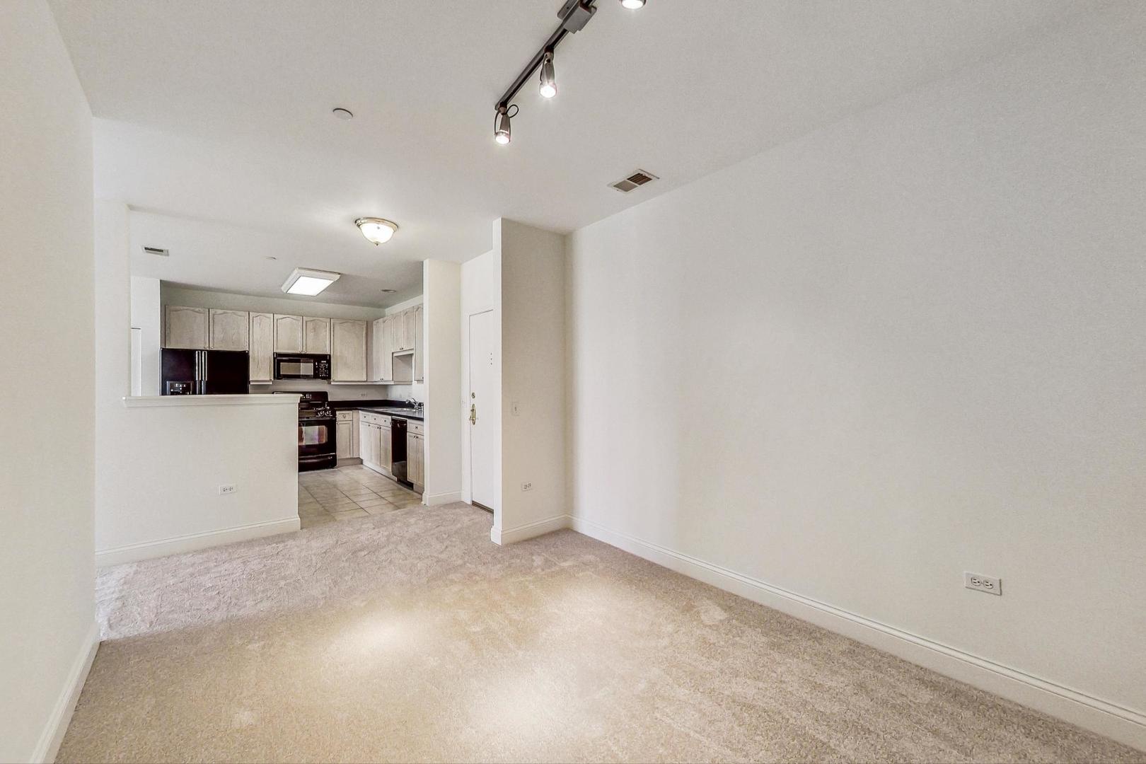 620 McHenry Road, Unit 407 Wheeling, IL 60090 - Photo 17 of 23 a view of kitchen with wooden floor