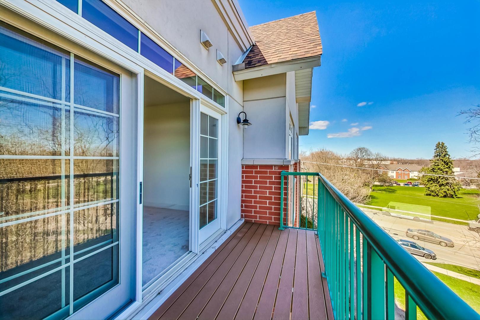 620 McHenry Road, Unit 407 Wheeling, IL 60090 - Photo 21 of 23 a balcony with an ocean view