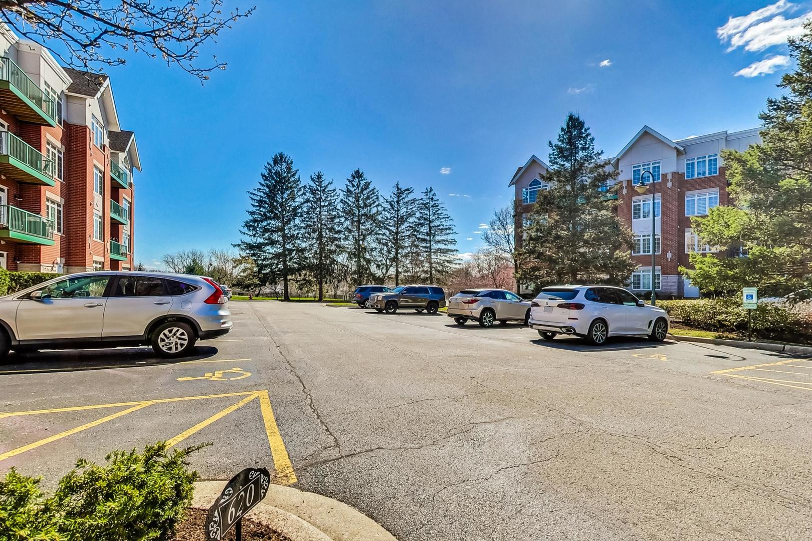 620 McHenry Road, Unit 407 Wheeling, IL 60090 - Photo 23 of 23 a view of a cars parked in front of a building