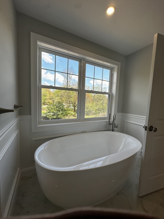 56 Dudley Road Billerica, MA 01821 - Photo 19 of 29 a white bath tub sitting in a bathroom next to a window