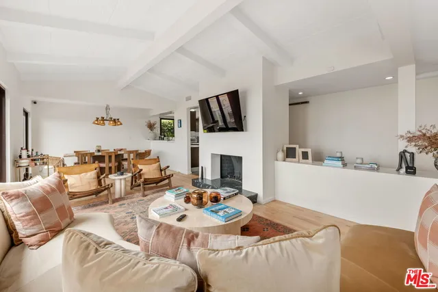 a living room with furniture fireplace and a flat screen tv