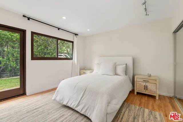 a bedroom with a bed and a large window