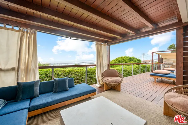 a bedroom with furniture and a large window