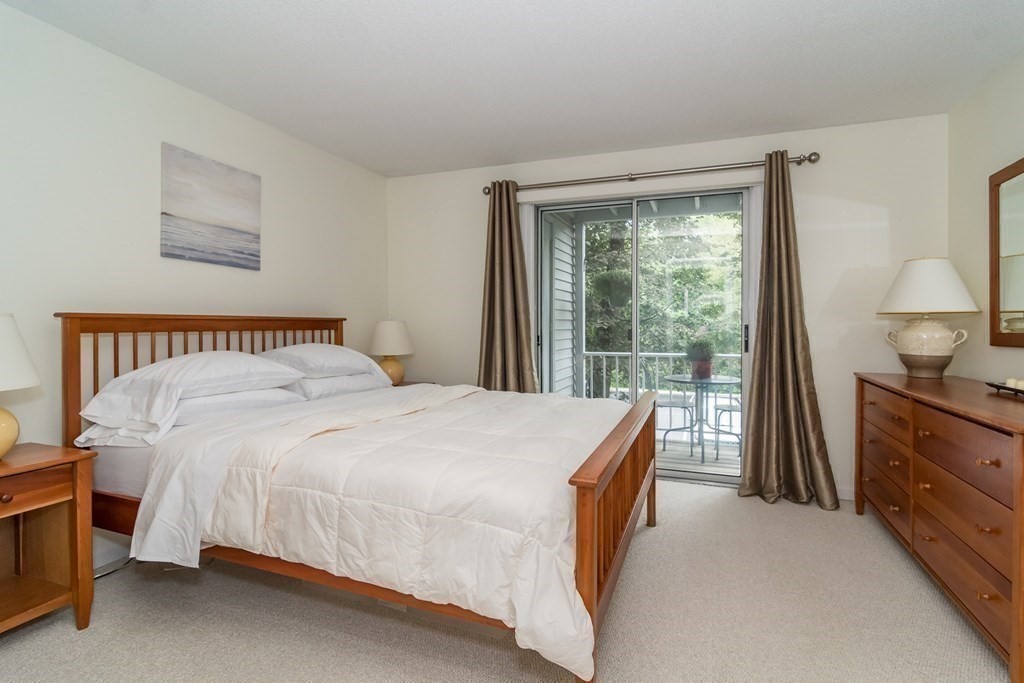 30 Walden Drive, Unit 7 Natick, MA 01760 - Photo 12 of 18 a bedroom with a bed and a dresser next to a window