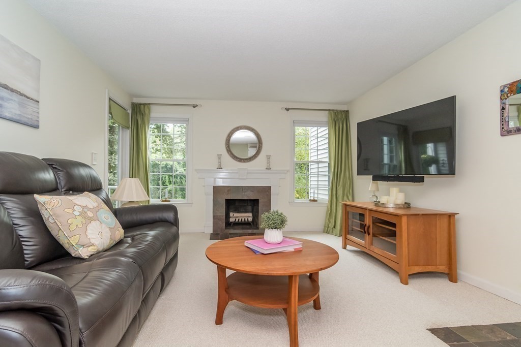 30 Walden Drive, Unit 7 Natick, MA 01760 - Photo 2 of 18 a living room with furniture flat screen tv and a fireplace