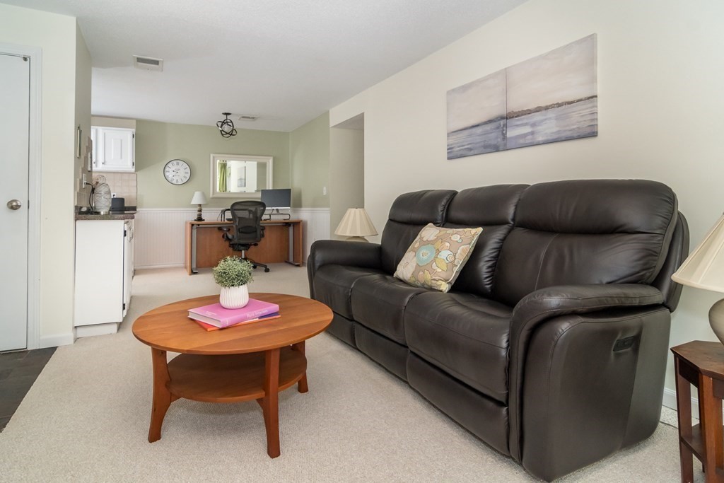 30 Walden Drive, Unit 7 Natick, MA 01760 - Photo 3 of 18 a living room with furniture and a table