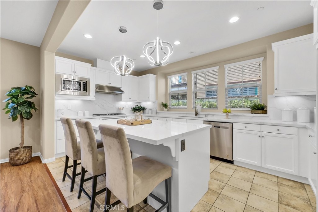 3515 Gardenia Lane Brea, CA 92823 - Photo 8 of 46 a kitchen with granite countertop a sink a center island stainless steel appliances and cabinets