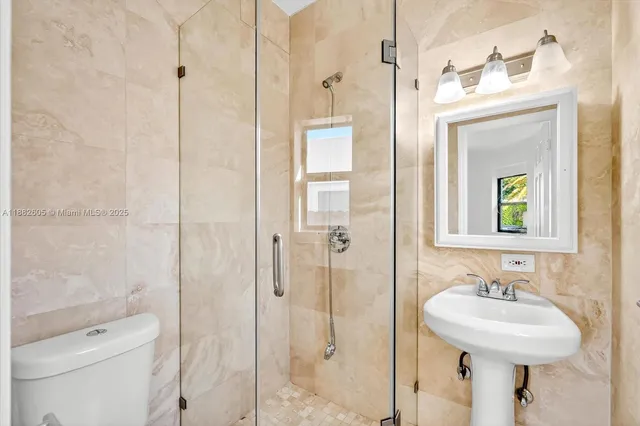 a bathroom with a sink toilet and shower