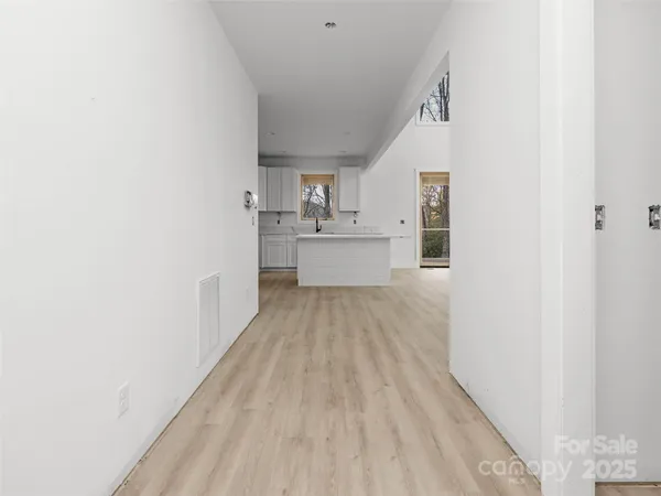 a view of a kitchen with wooden floor and electronic appliances