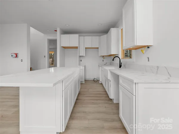 a kitchen with a sink a counter top space and cabinets