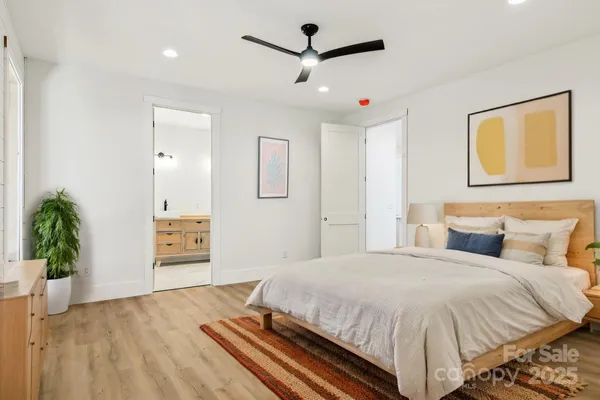 a view of a patio with couple of chairs and potted plants