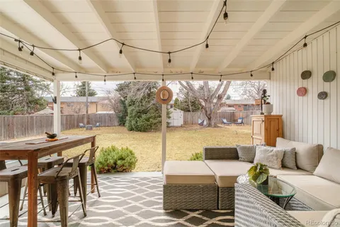 a building outdoor space with patio furniture and potted plants