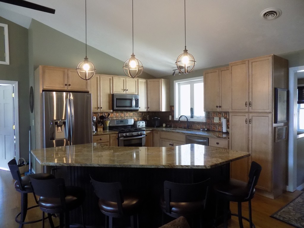 43 Brookfield Road Brimfield, MA 01010 - Photo 3 of 16 a kitchen with refrigerator a sink and chairs