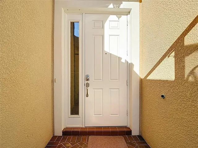 a view of a hallway with wooden floor and a bathroom