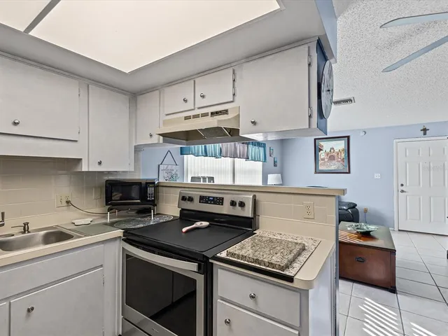 a kitchen with stainless steel appliances granite countertop a stove and a refrigerator