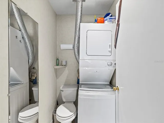 a white toilet sitting next to a bathroom sink